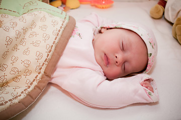Image showing sleeping peaceful baby girl in a pink pagama