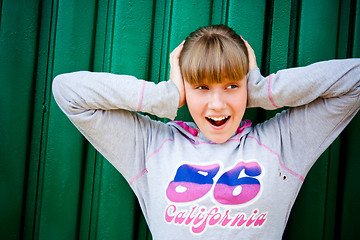 Image showing teenage girl hiding from noise