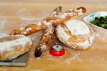 Image showing Baguettes and breads on wooden table