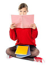 Image showing Girl sitting with books on her lap