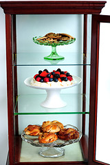 Image showing Shelf decorated by delicious desserts