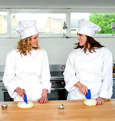 Image showing Two female chefs looking at each other