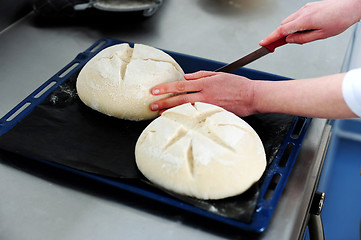 Image showing Female cutting dough in a creative manner