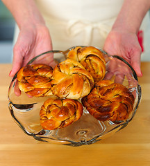 Image showing Female hands showing fresh rolls