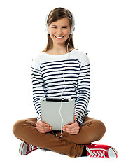 Image showing Teenager enjoying music through headphones