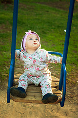 Image showing little girl  on the swings