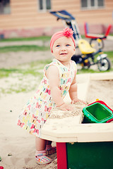 Image showing Cute girl playing with the sand