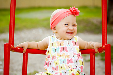 Image showing Cute little girl on the swings