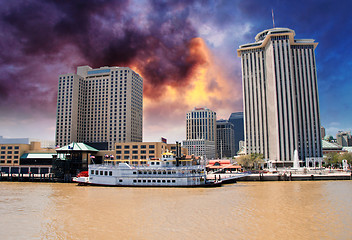 Image showing Skyscrapers and Buildings over a Brown River