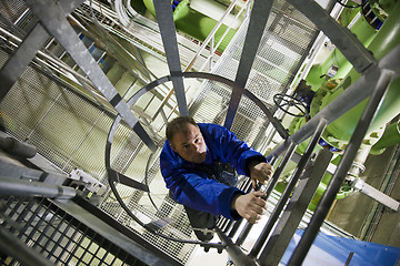 Image showing Engineer climbing ladder