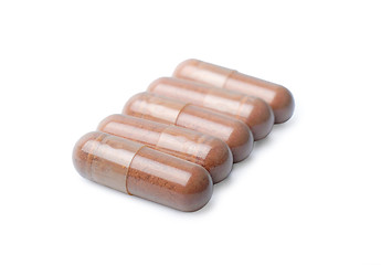 Image showing Brown capsules isolated on a white background