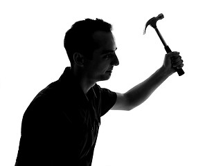 Image showing Silhouette of a man working with hammer