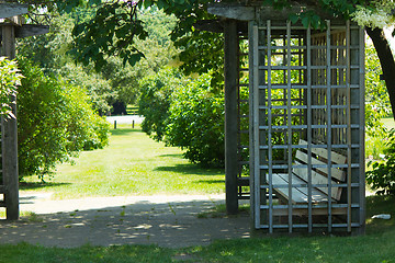 Image showing Gazebo with bench in a garden