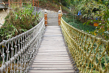 Image showing Adventure wooden rope suspension bridge in jungle rainforest