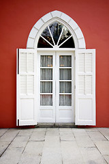 Image showing White door on red wall background