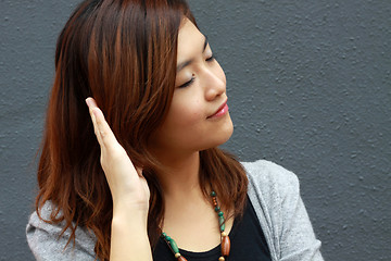 Image showing Asian woman hearing voice
