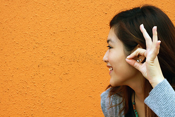 Image showing Asian woman hearing voice