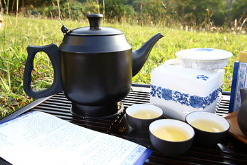 Image showing Asian tea set on grasses