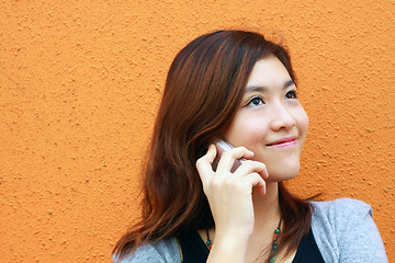 Image showing Asian woman calling and talking on phone