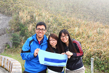 Image showing Mountain hikers reach the hill top and showing their victory