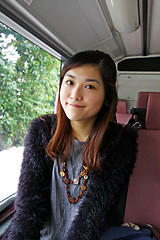 Image showing Asian woman in the bus and smiling