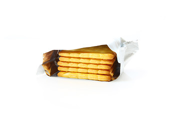 Image showing Stack of biscuits in bag isolated on white background
