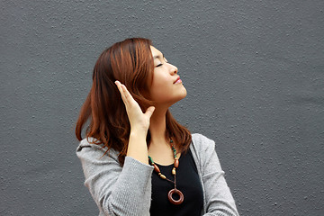 Image showing Asian woman hearing voice