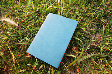 Image showing Notebook on the grasses