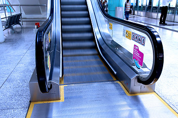 Image showing Moving escalator in blue tone