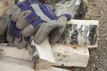 Image showing Gloves and  birch firewood