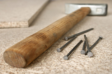 Image showing Hammer and a handful of nails