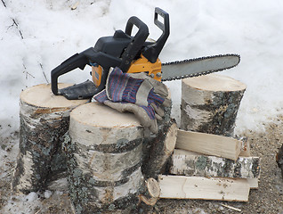 Image showing Firewood and a chainsaw