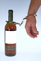 Image showing Wine and handcuffs