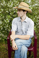 Image showing A young man in a cherry garden