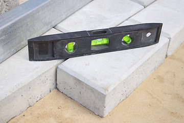 Image showing Level gauge it is applied at stone blocks laying