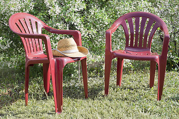 Image showing Plastic chairs in the garden