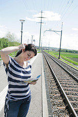 Image showing Young woman confused on which direction to choose in a empty rai