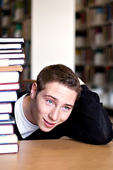 Image showing Overwhelmed Student with Piled Books