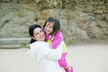 Image showing happy mom and daughter smiling at nature 