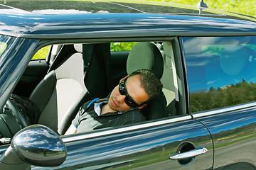 Image showing man sleeps in a car 