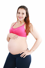 Image showing pregnant woman caressing her belly over white background 