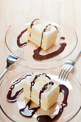 Image showing fresh cream cake closeup with chocolate sauce