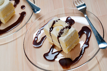 Image showing fresh cream cake closeup with chocolate sauce