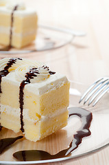 Image showing fresh cream cake closeup with chocolate sauce