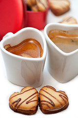 Image showing heart shaped cream cookies on red heart metal box and coffee