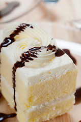 Image showing fresh cream cake closeup with chocolate sauce