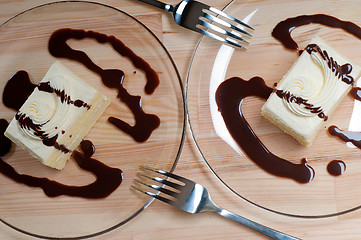 Image showing fresh cream cake closeup with chocolate sauce