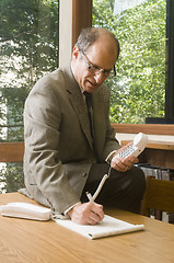 Image showing senior business executuve in conference room office talking on t