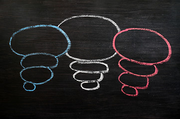 Image showing Blank speech bubbles drawn in chalk on a blackboard 