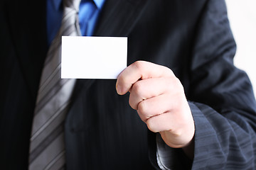 Image showing Successful businessman holding empty card 